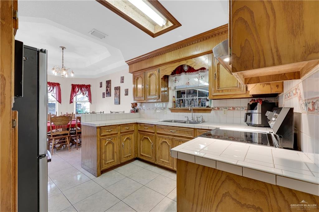 1607 West Main Street Rio Grande City, TX 78582 - Photo 9 of 31 a kitchen with stainless steel appliances a sink and counter space