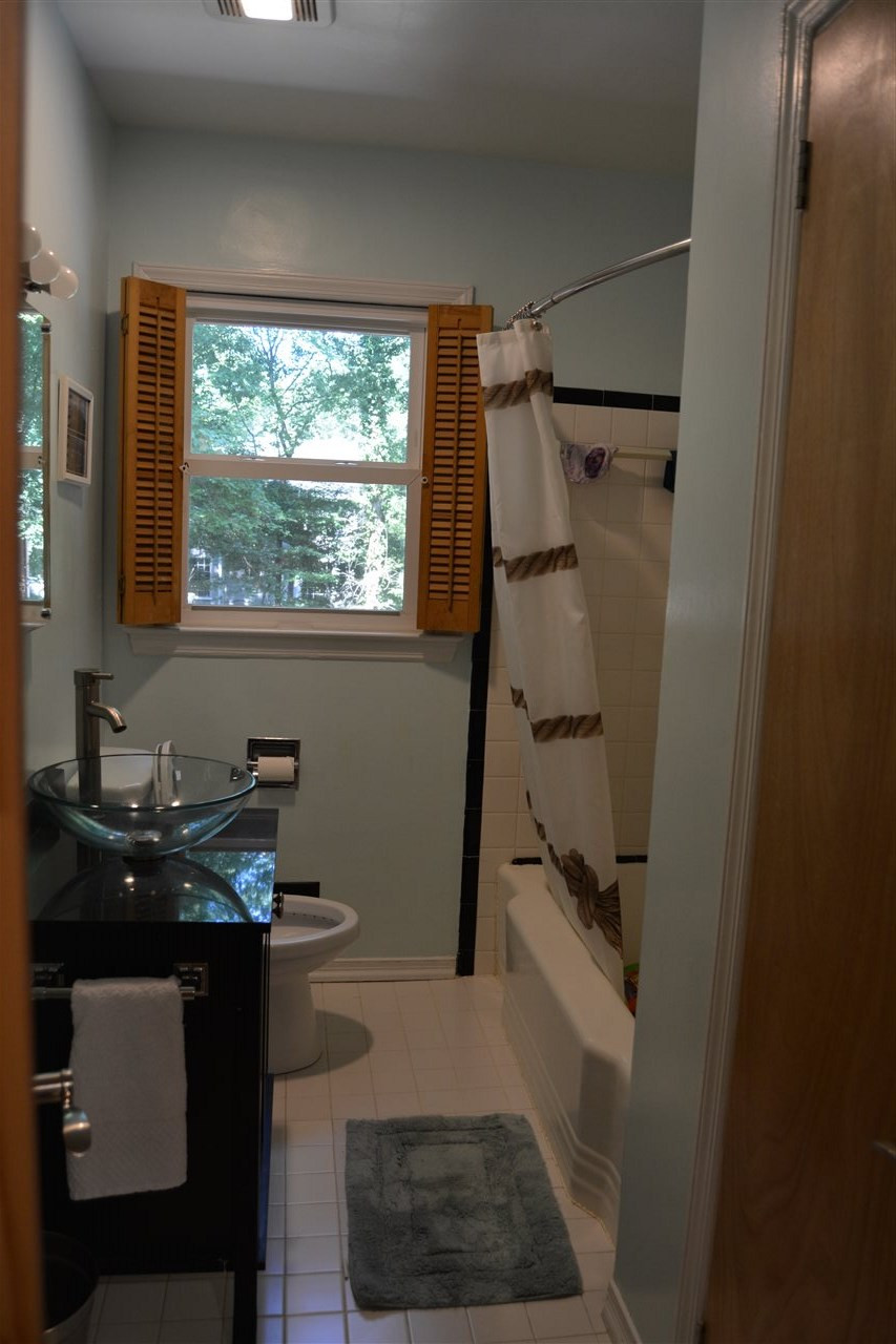 3123 Childers Street Raleigh, NC 27612 - Photo 10 of 25 Bathroom with new painted tub, low flow toilet, and update sink/cabinet. Bathroom