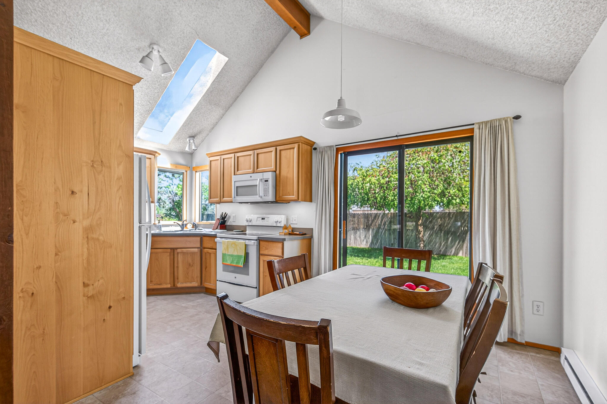 60866 Brosterhous Road Bend, OR 97702 - Photo 12 of 41 a kitchen with a table chairs and wooden floor