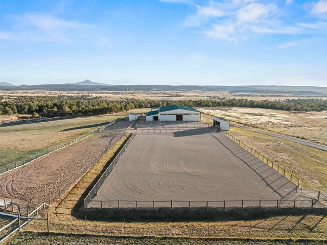 a view of swimming pool with outdoor seating and yard in back