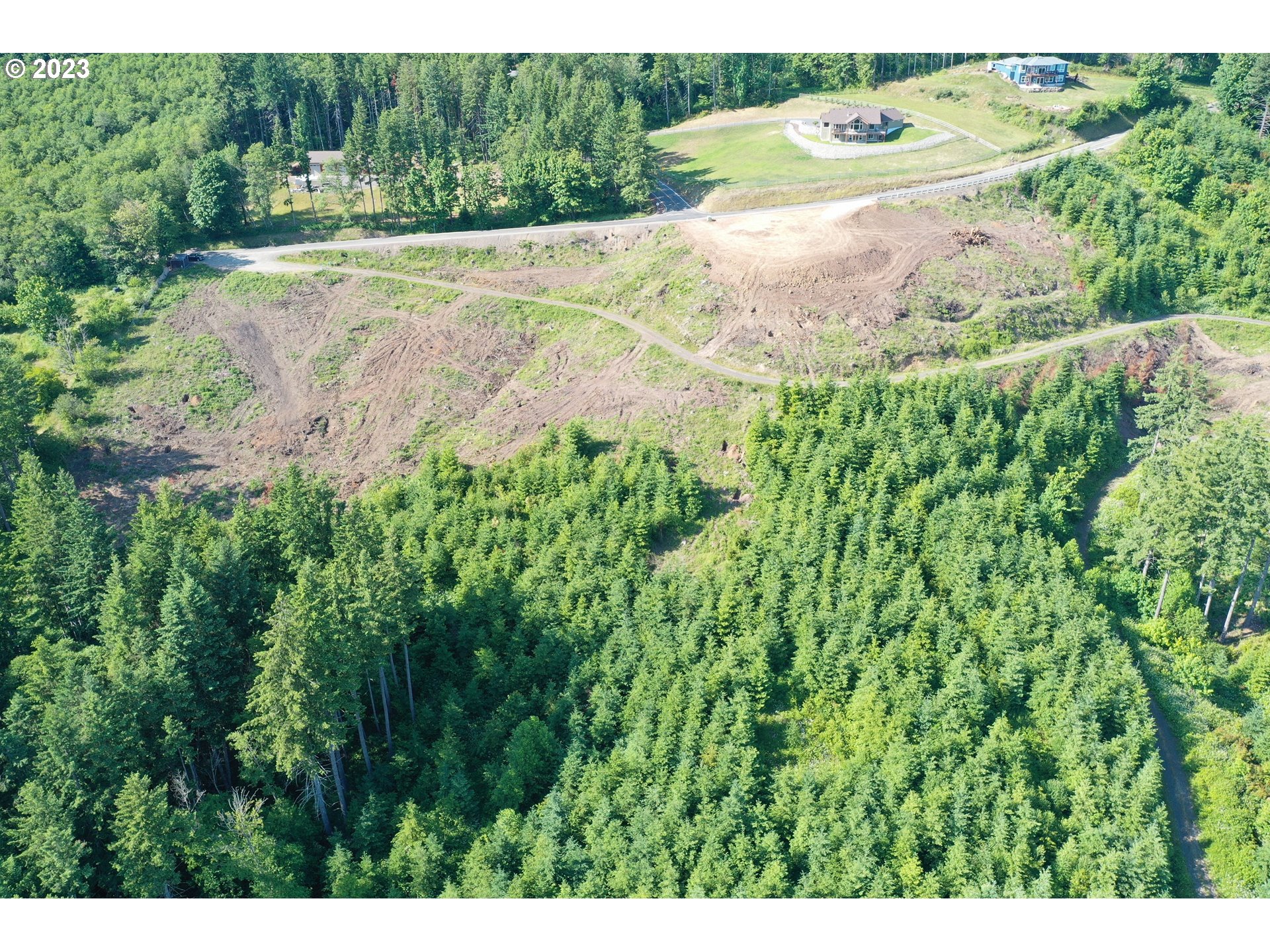 2987 Green Mountain Road, Unit D Kalama, WA 98625 - Photo 15 of 19 a view of grassy field with trees in the background