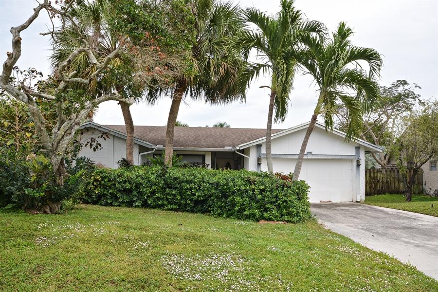 21536 Toledo Road Boca Raton, FL 33433 - Photo 1 of 19 a front view of a house with a garden
