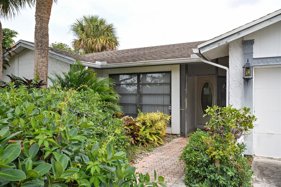 21536 Toledo Road Boca Raton, FL 33433 - Photo 3 of 19 front view of a house with a yard