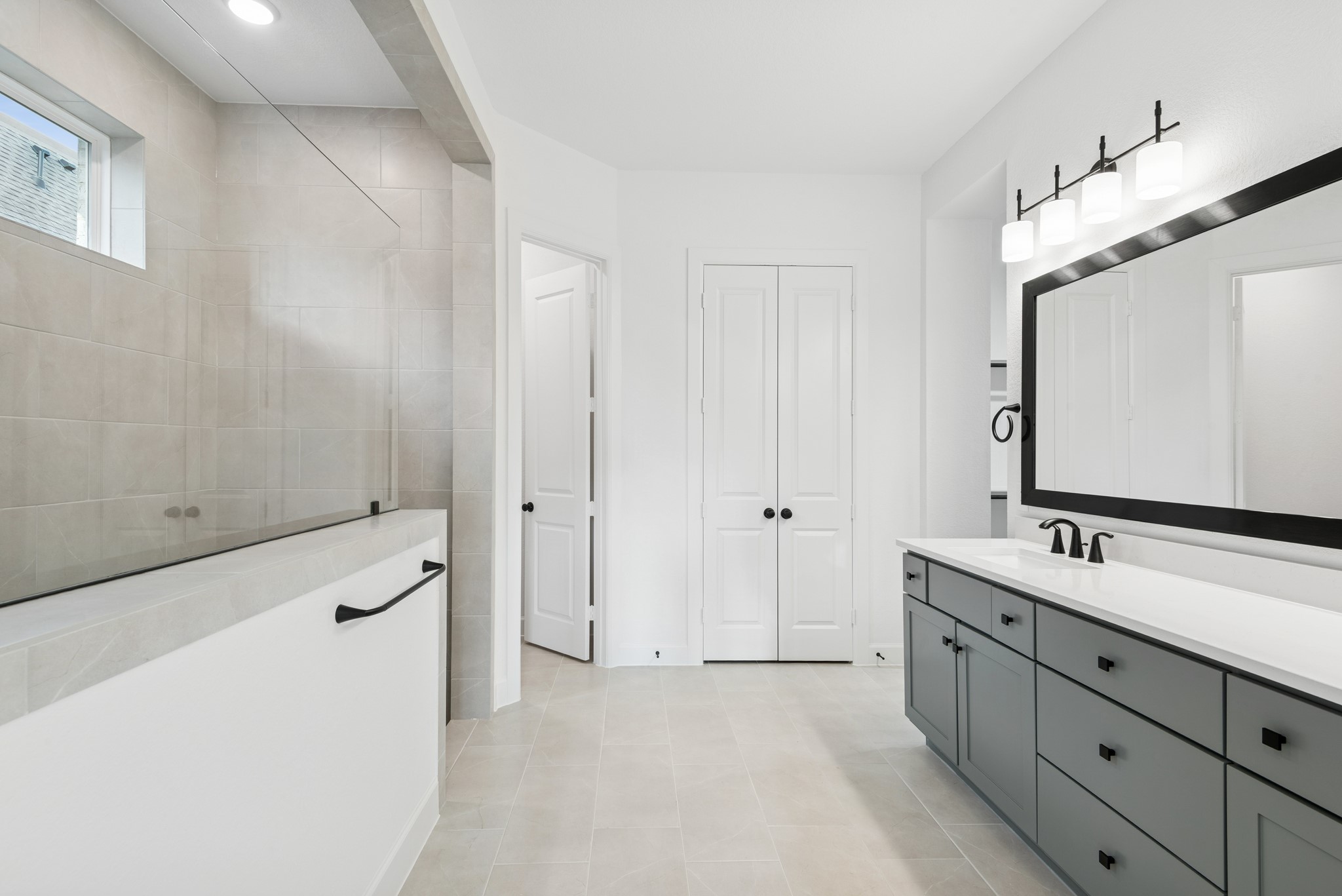 15714 Terracotta Terrace Lane Conroe, TX 77302 - Photo 37 of 47 a bathroom with a double vanity sink a mirror and a shower