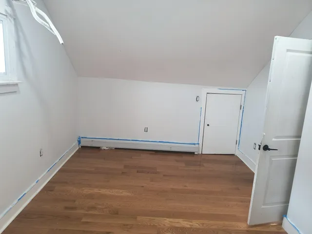 a view of wooden floor and windows in a room