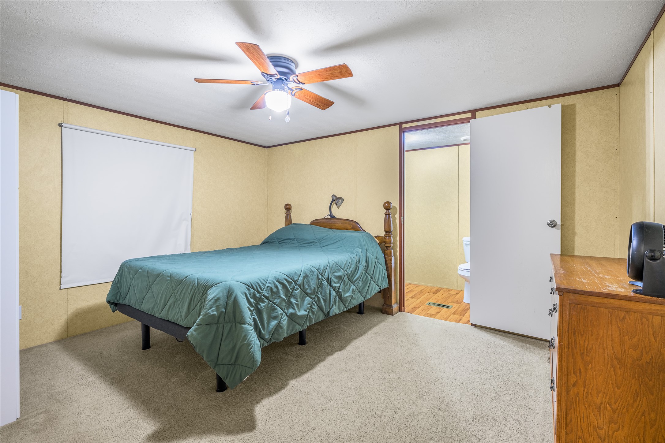 3940 Davis Road West Point, TX 78963 - Photo 13 of 22 a bedroom with a bed and a chandelier
