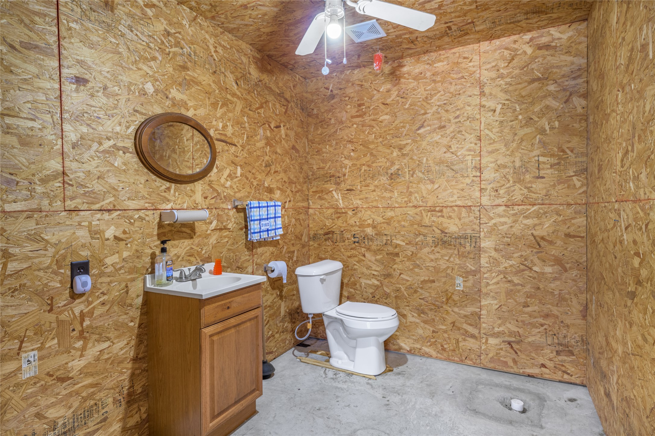 3940 Davis Road West Point, TX 78963 - Photo 20 of 22 a bathroom with a toilet sink vanity and mirror