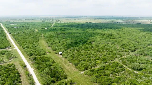 a view of a field with an ocean view