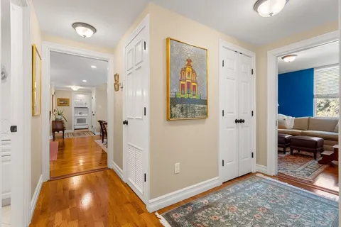 a view of a hallway view with living room and dining room view