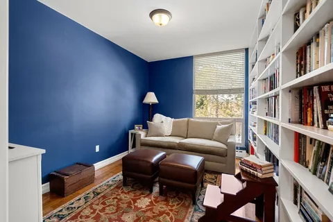 a living room with a couch and a book shelf