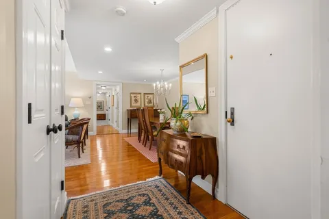 a living room with furniture a table and wooden floor