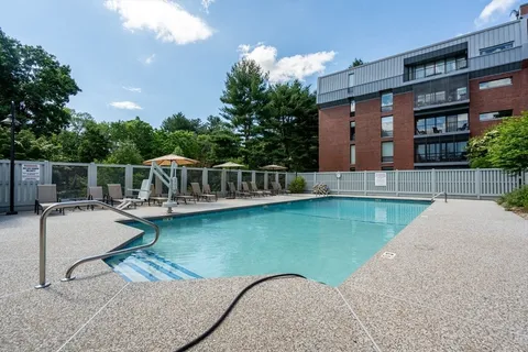 a view of a house with swimming pool and a yard