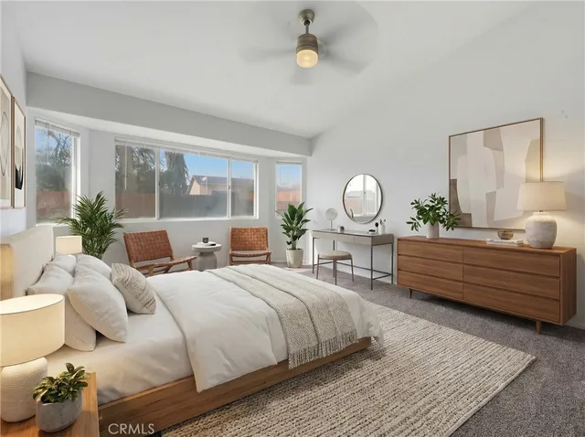 an empty room with wooden floor and fan