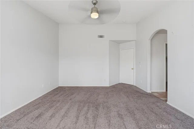 a white bath tub sitting next to a white sink and vanity