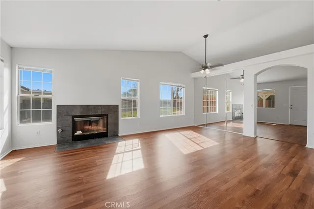 a living room with furniture a dining table and a fireplace