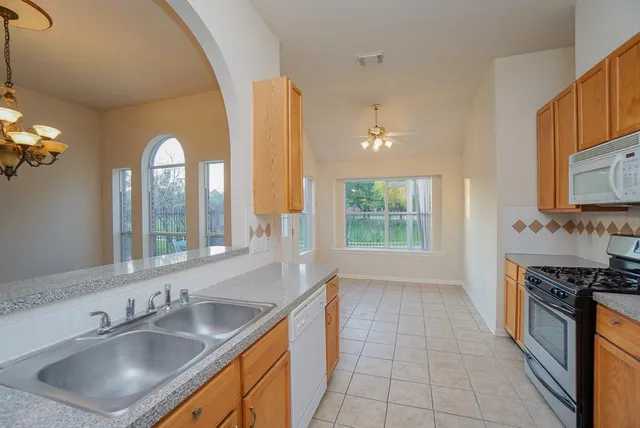 a kitchen with a sink and a stove top oven