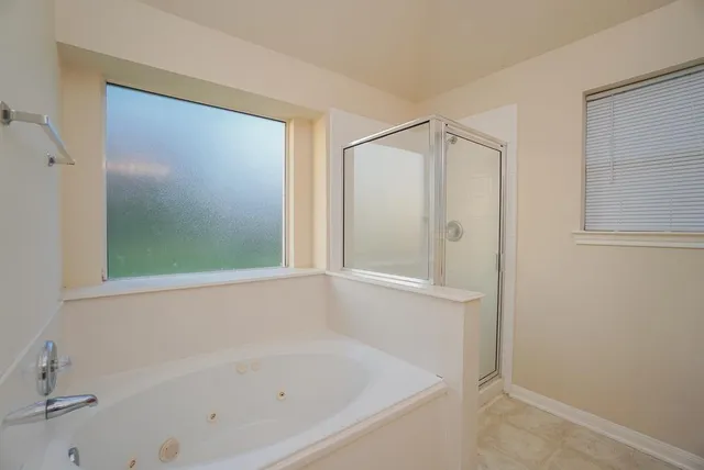 a white bath tub sitting next to a window