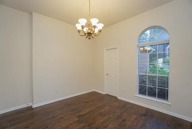 a view of livingroom with chandelier fan and wooden floor