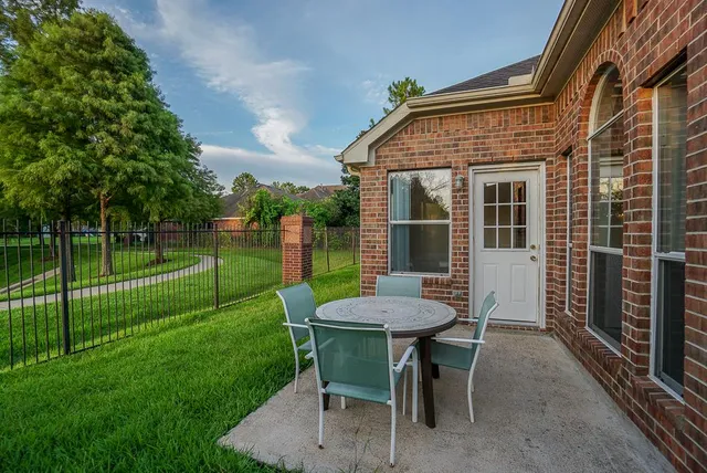 a view of a house with backyard and sitting area