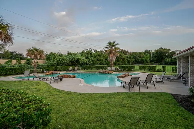 a view of a swimming pool with a table and chairs