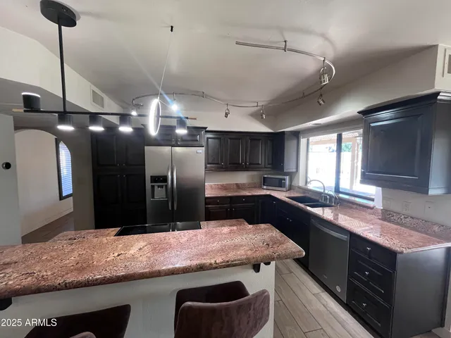 a kitchen with a counter space appliances and a counter space