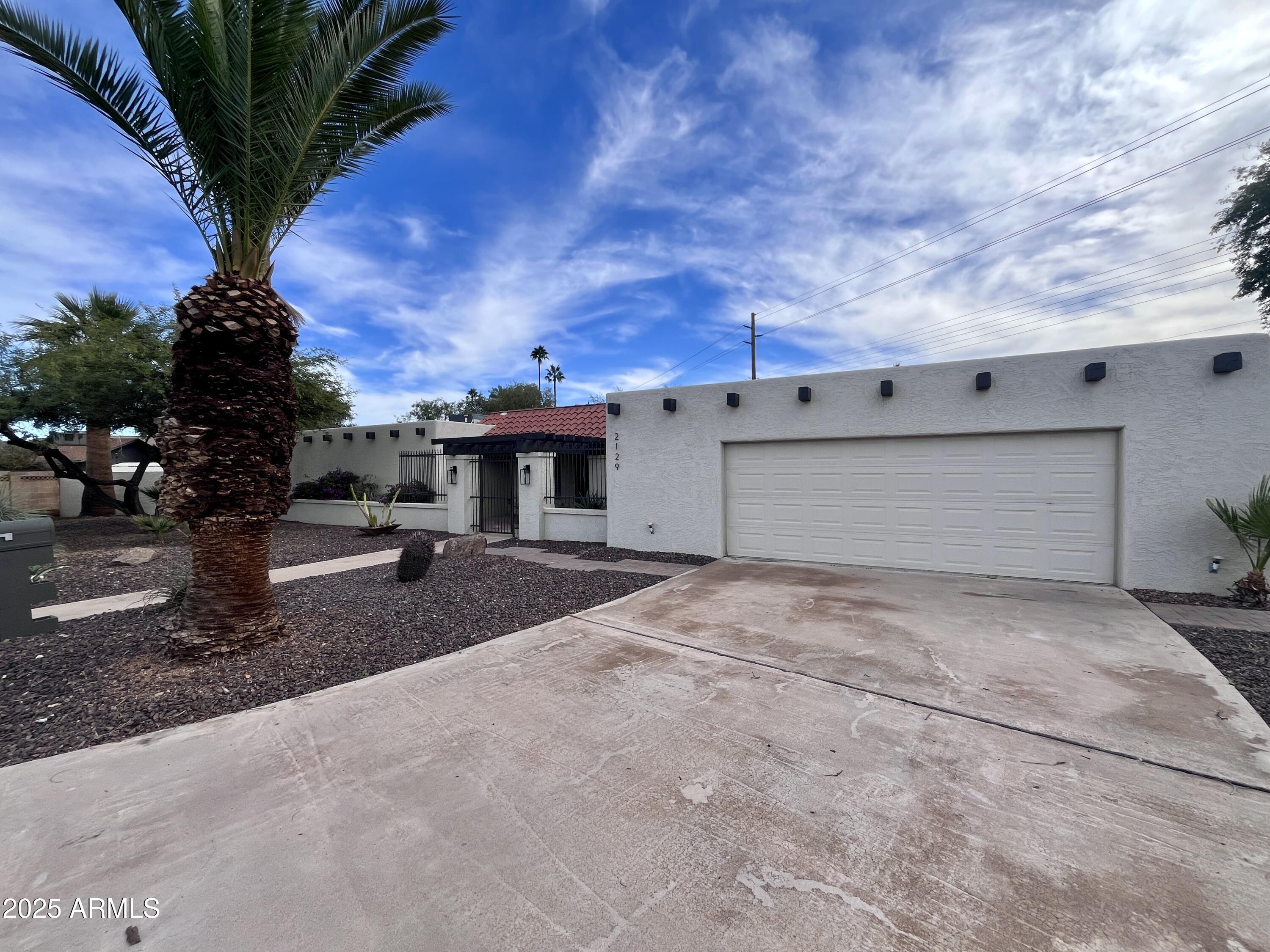 2129 East Huntington Drive Tempe, AZ 85282 - Photo 2 of 36 a view of a house with a yard and garage