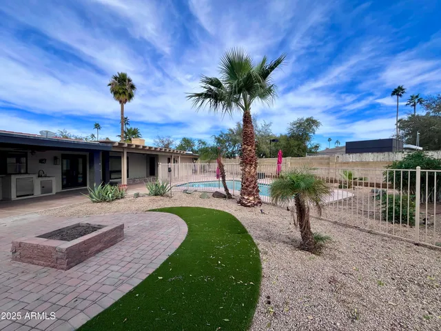 a front view of a house with a garden and patio