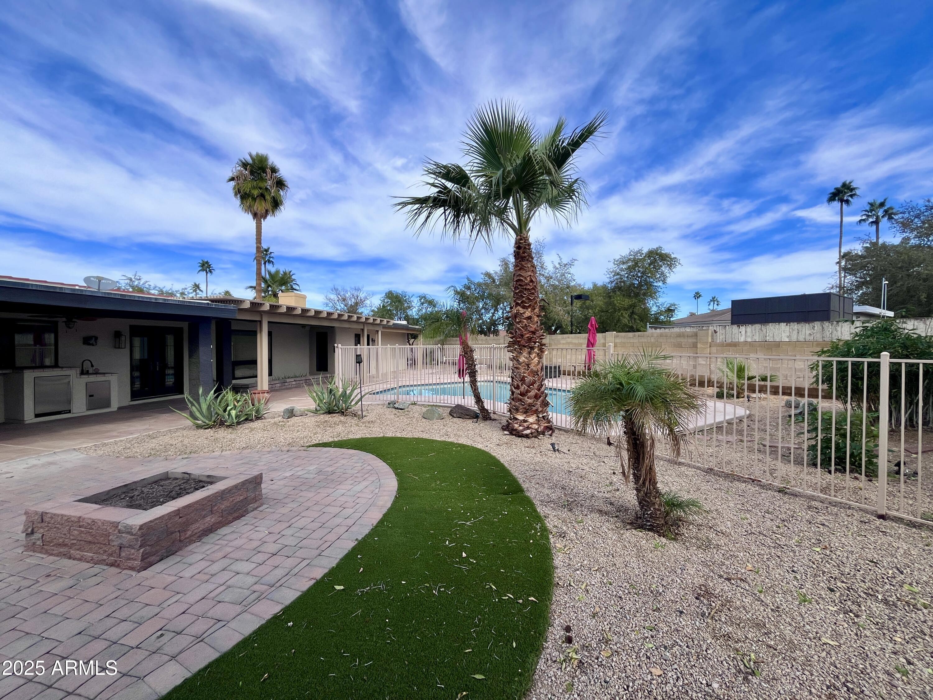 2129 East Huntington Drive Tempe, AZ 85282 - Photo 28 of 36 a front view of a house with a garden and patio