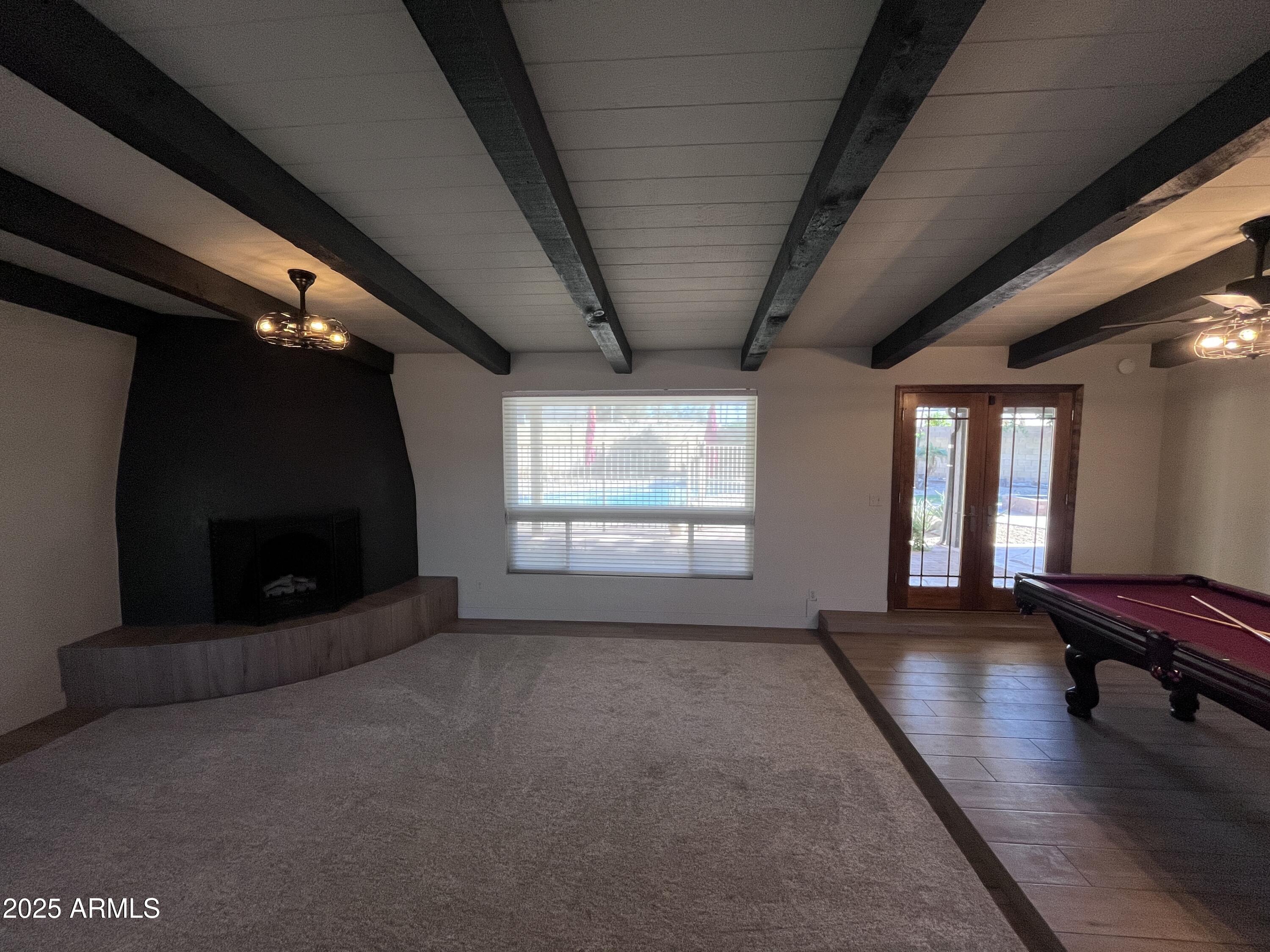 2129 East Huntington Drive Tempe, AZ 85282 - Photo 5 of 36 a view of a livingroom with wooden floor and a fireplace