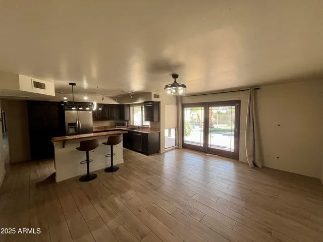 a living room with furniture and kitchen view