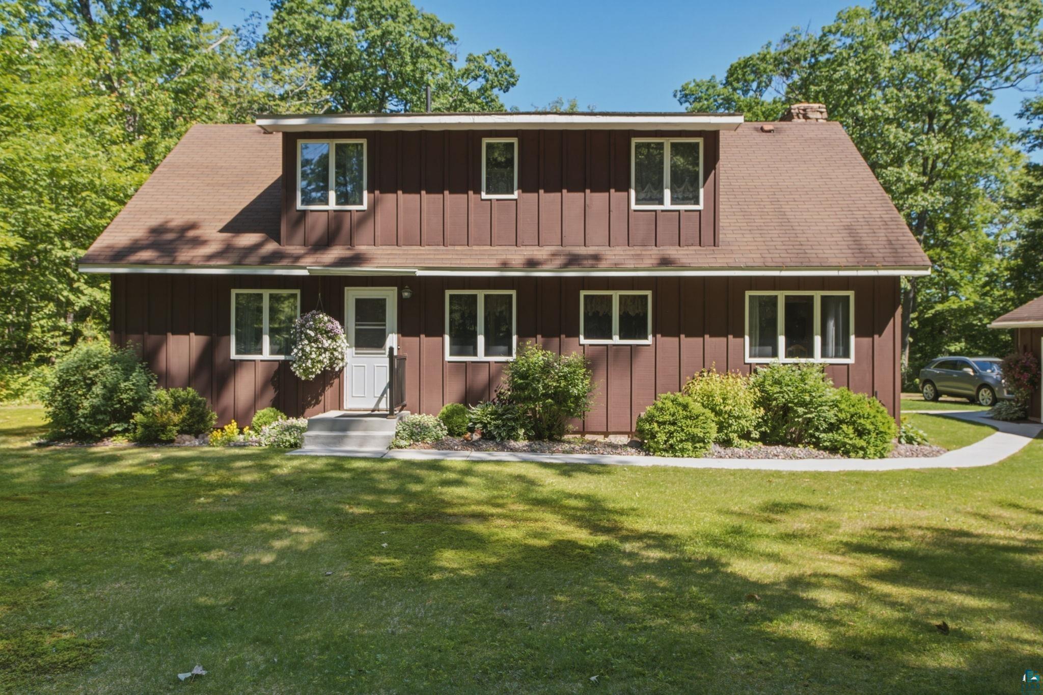 27485 South Kane Road Ashland, WI 54806 - Photo 25 of 35 Two-story brown exterior with white trim windows and a brown shingle roof
