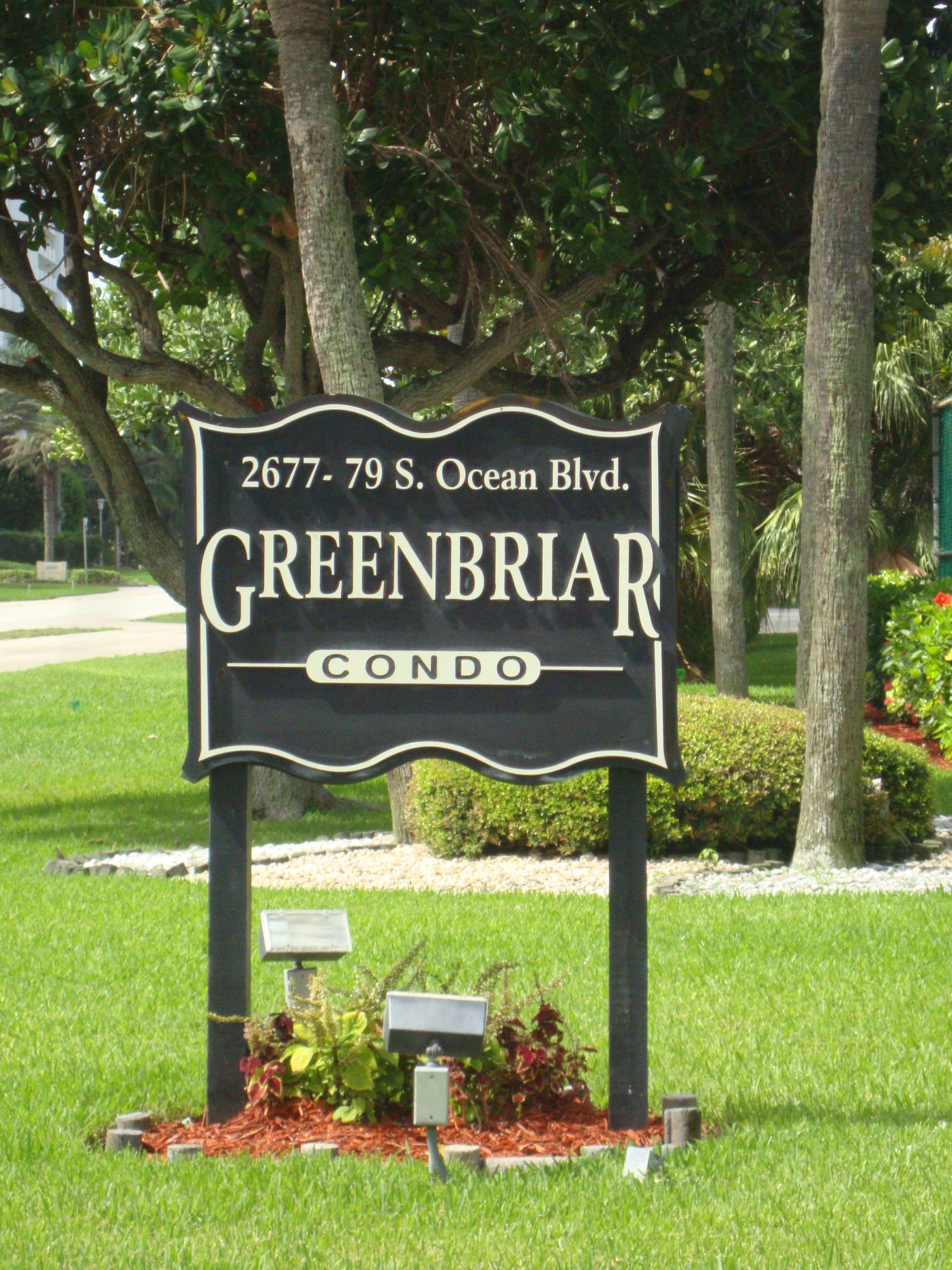 a view of a park that has a sign board