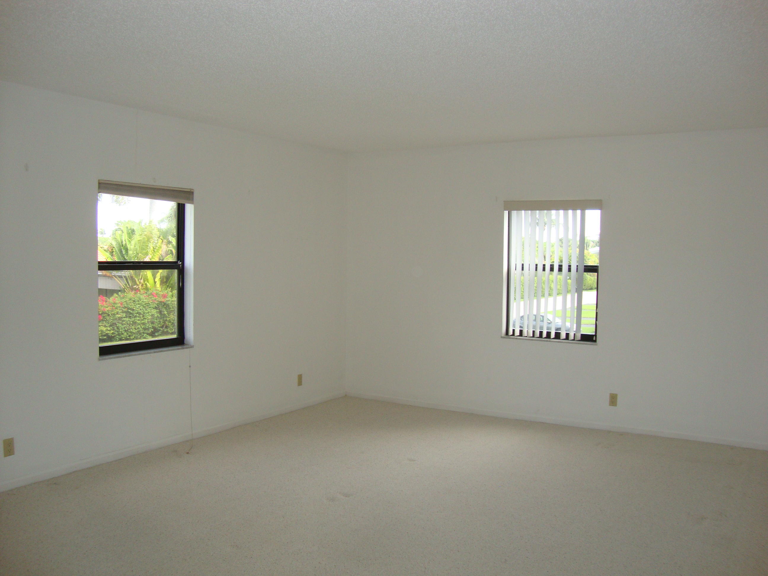 2679 South Ocean Boulevard, Unit 2B Boca Raton, FL 33432 - Photo 13 of 42 an empty room with windows
