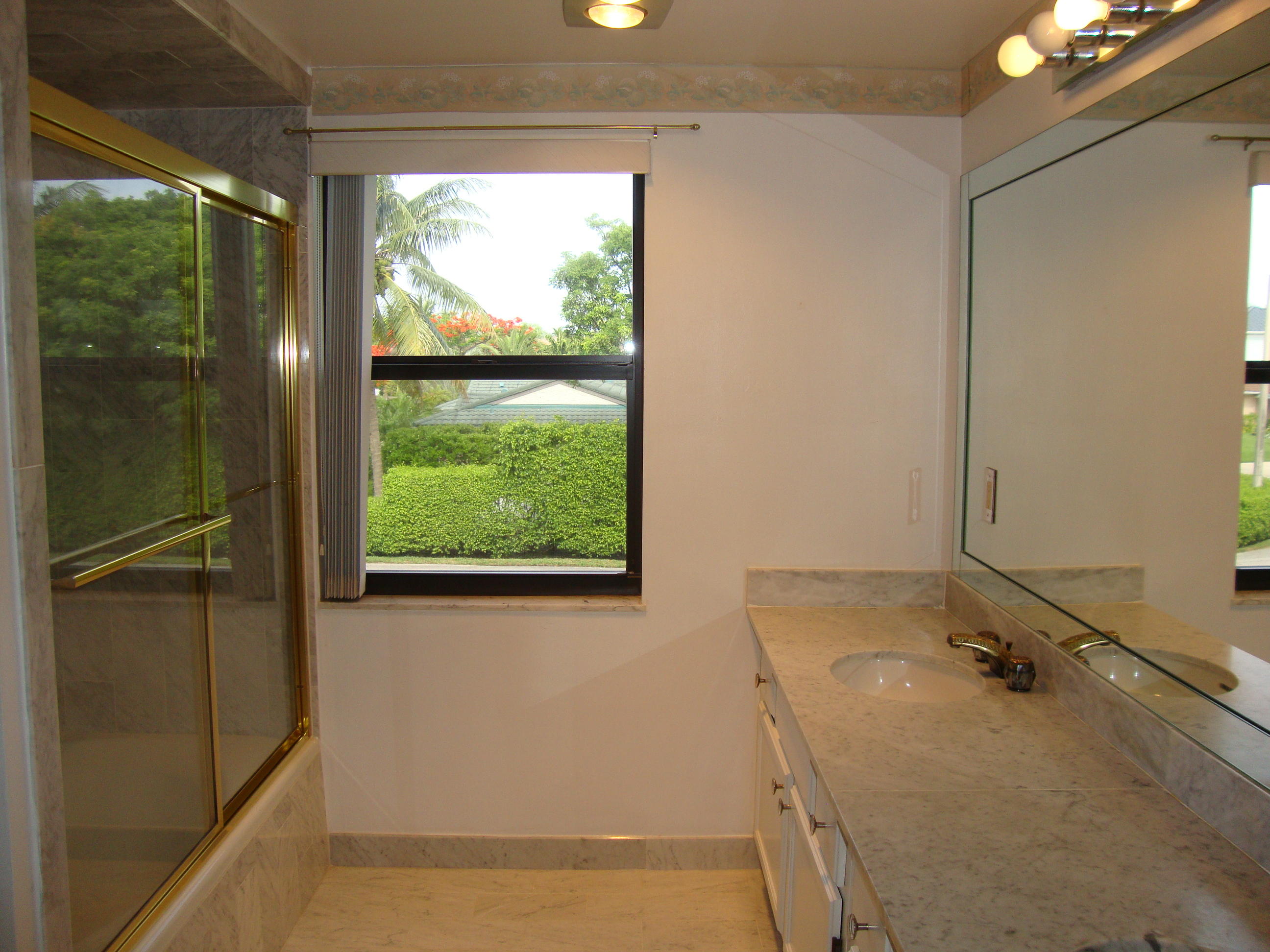 2679 South Ocean Boulevard, Unit 2B Boca Raton, FL 33432 - Photo 15 of 42 a bathroom with a tub and a sink