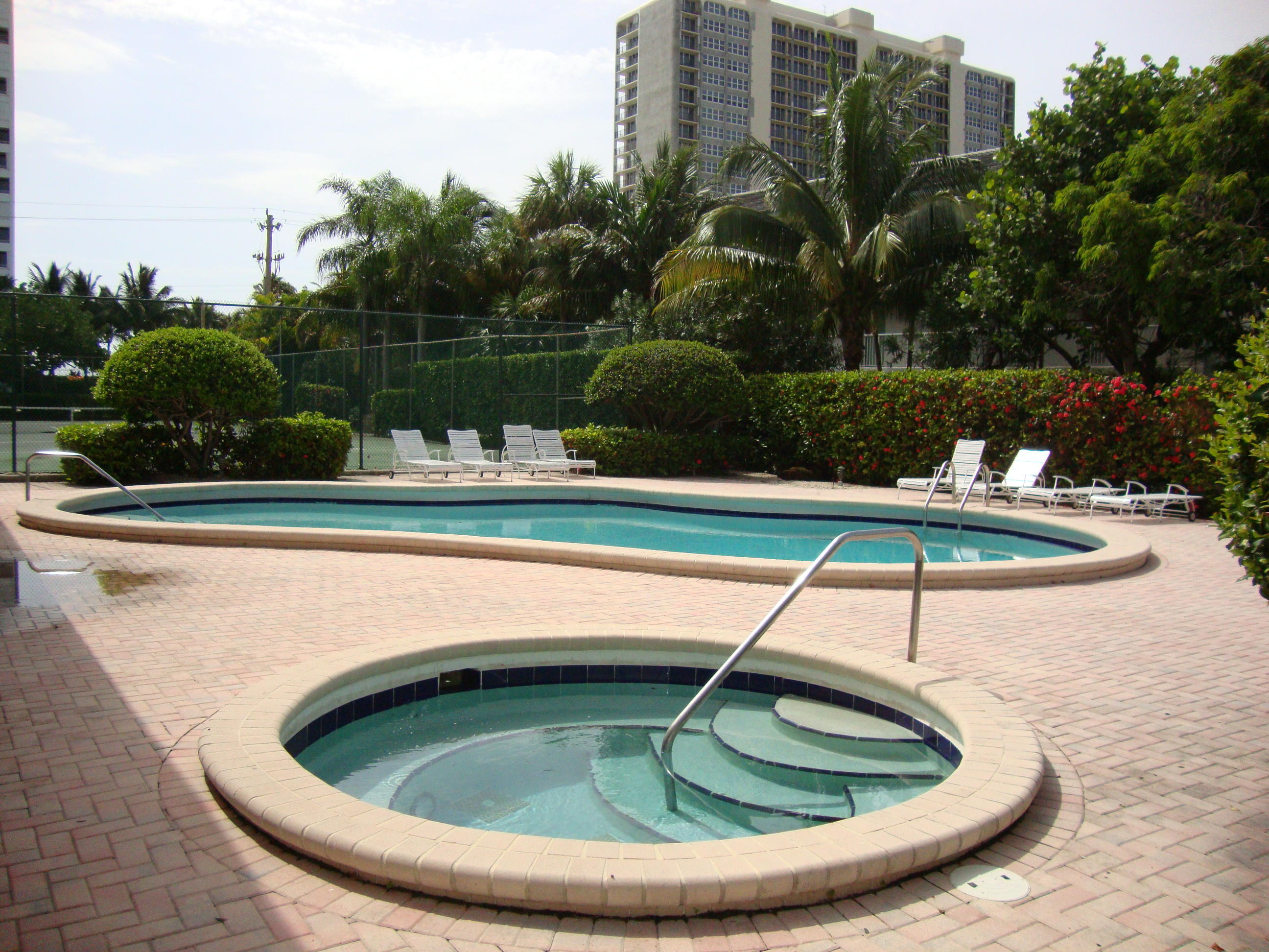 2679 South Ocean Boulevard, Unit 2B Boca Raton, FL 33432 - Photo 35 of 42 a small pool with outdoor seating and trees