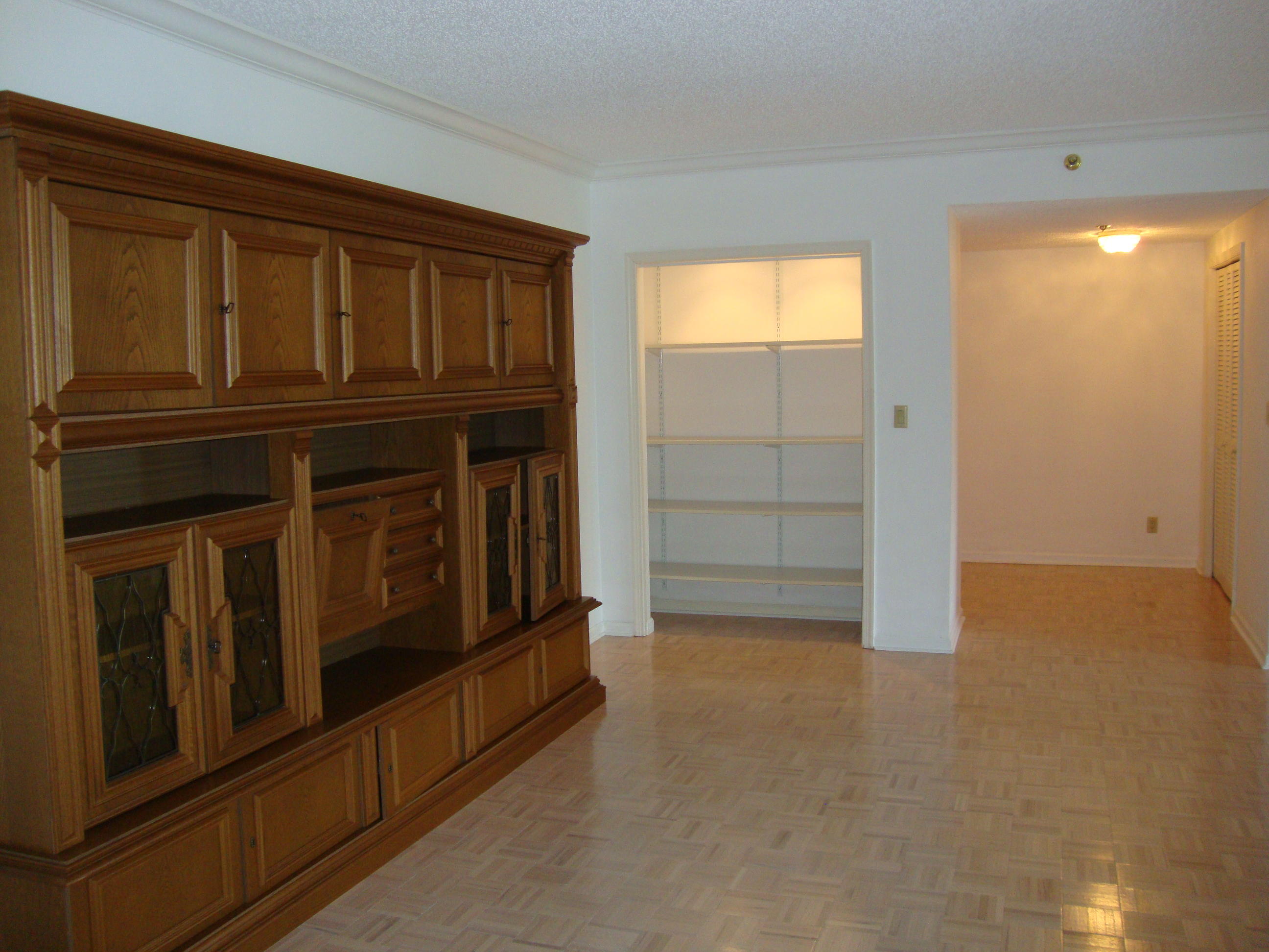 2679 South Ocean Boulevard, Unit 2B Boca Raton, FL 33432 - Photo 6 of 42 a view of an empty room with cabinet and a window