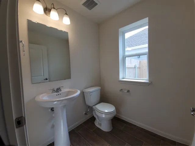 a white toilet sitting next to a bathroom sink