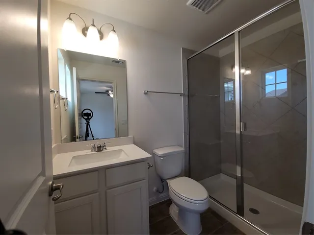 a bathroom with a sink toilet and shower