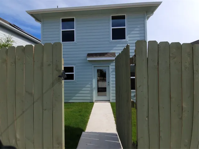 a pathway of a house with a small yard