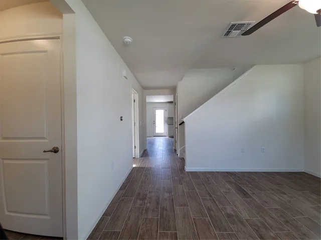 a view of a hallway with wooden floor