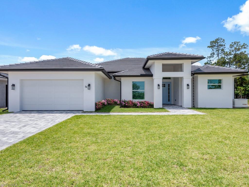 a front view of house with yard and outdoor seating