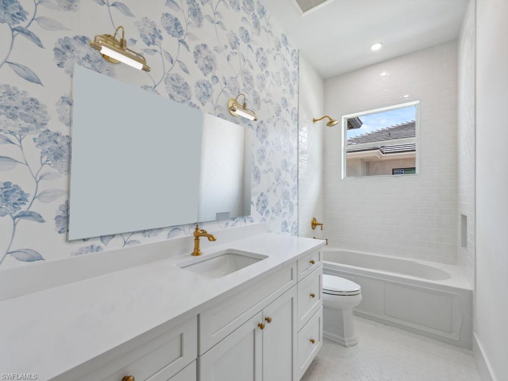 Undisclosed Address Naples, FL 34110 - Photo 11 of 27 a bathroom with a granite countertop sink a toilet and shower