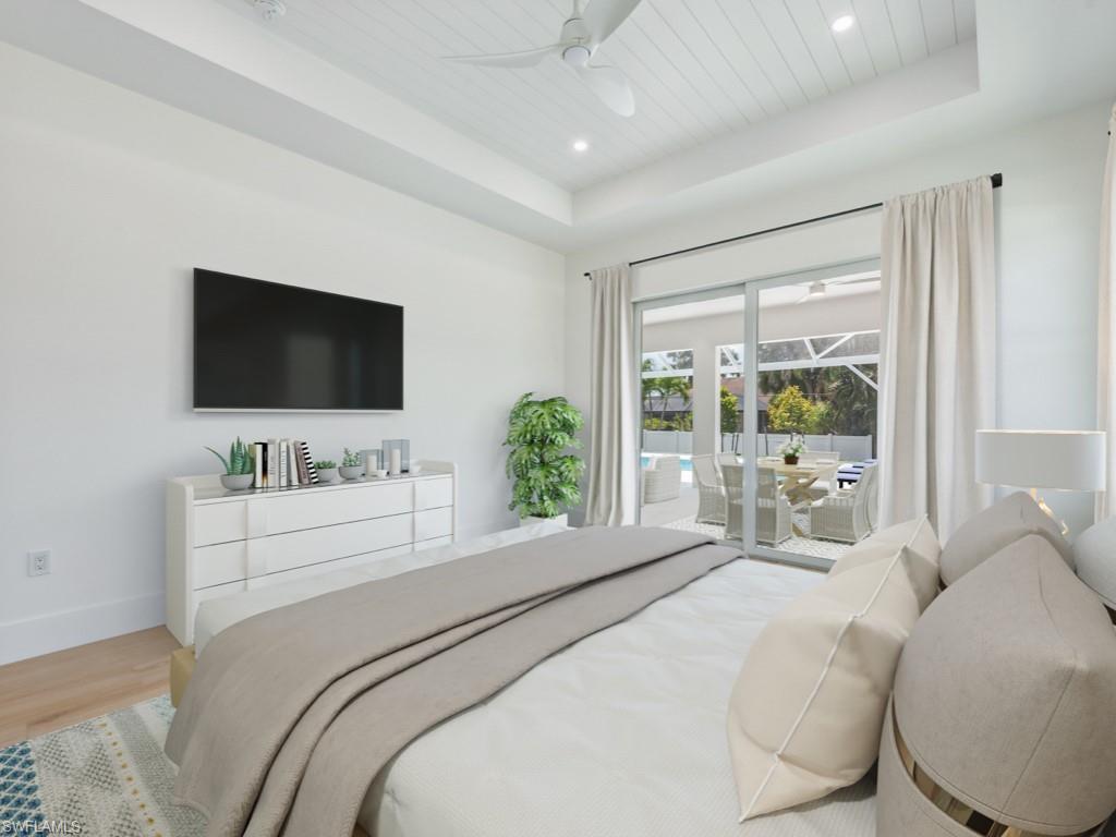 Undisclosed Address Naples, FL 34110 - Photo 14 of 27 a bedroom with a large bed and a flat screen tv
