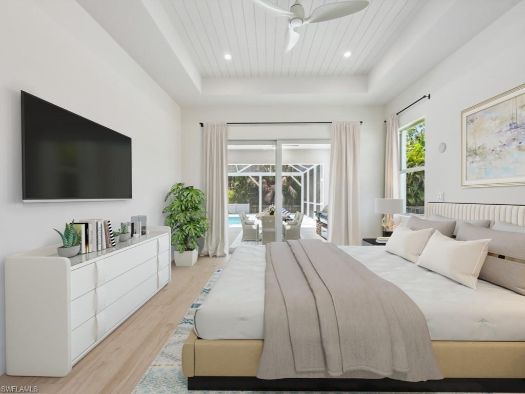 Undisclosed Address Naples, FL 34110 - Photo 15 of 27 a spacious bedroom with a large bed and a flat screen tv