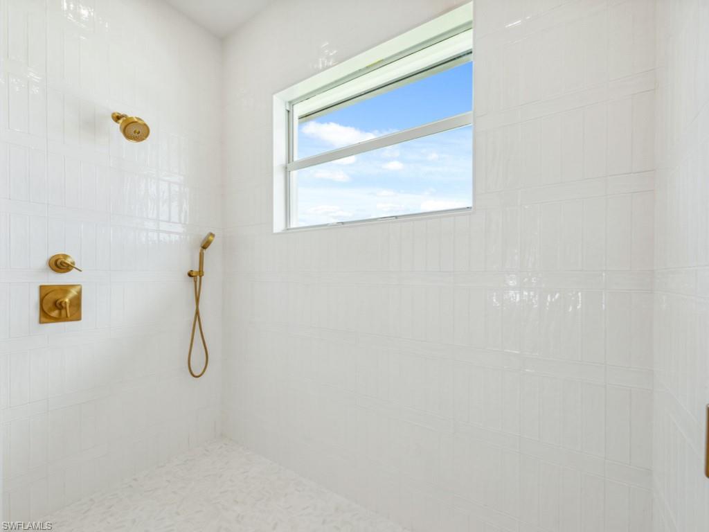 Undisclosed Address Naples, FL 34110 - Photo 17 of 27 a bathroom with a shower