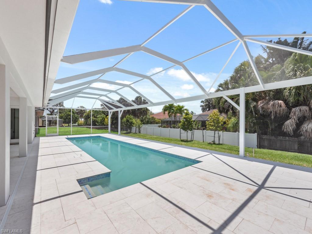 Undisclosed Address Naples, FL 34110 - Photo 20 of 27 a view of a backyard with swimming pool