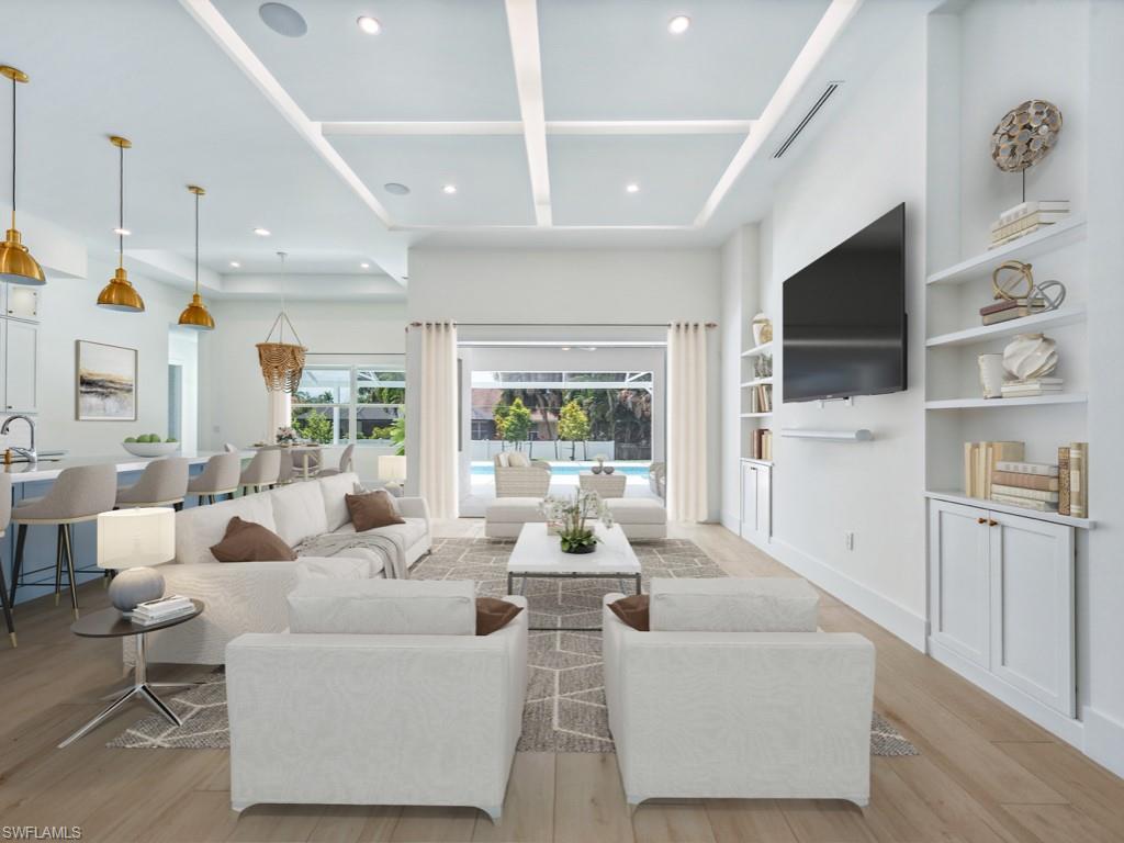 Undisclosed Address Naples, FL 34110 - Photo 2 of 27 a living room with furniture a flat screen tv and a large window