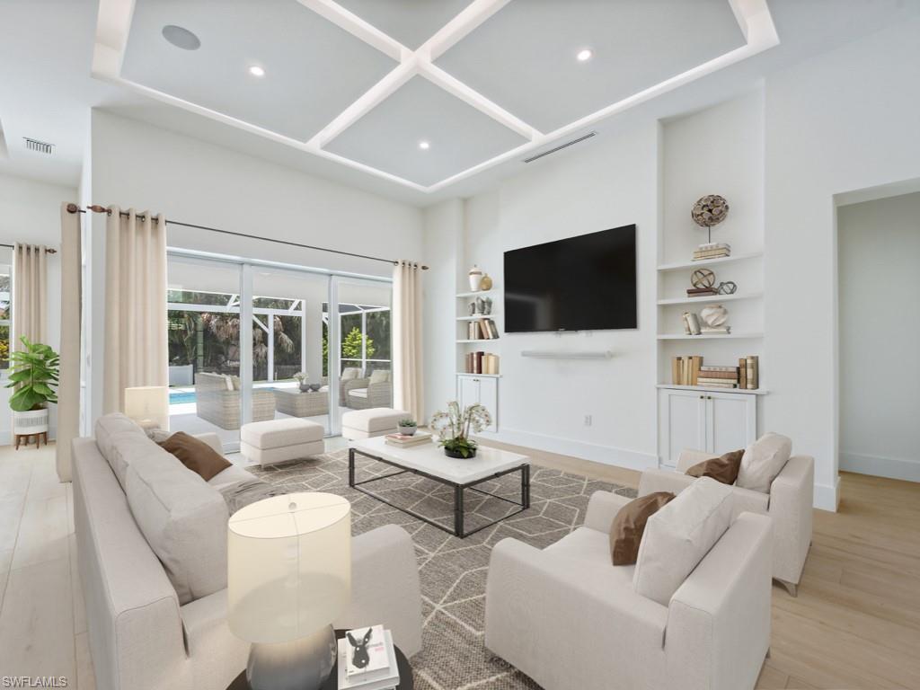 Undisclosed Address Naples, FL 34110 - Photo 3 of 27 a living room with furniture a flat screen tv and a large window