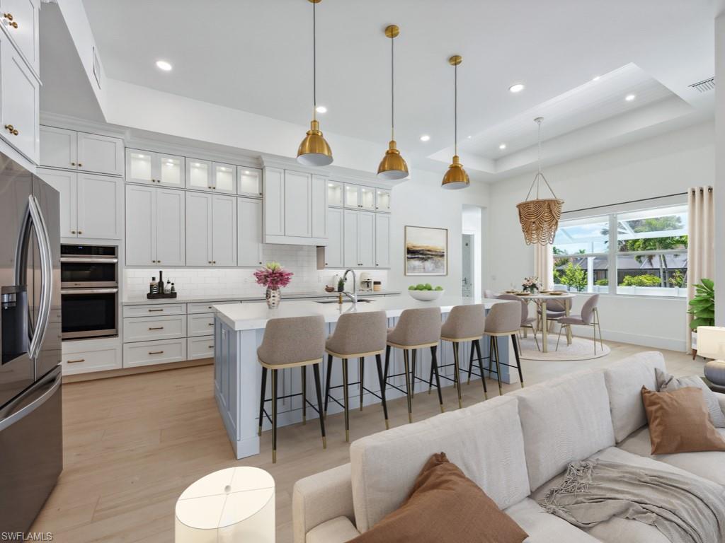 Undisclosed Address Naples, FL 34110 - Photo 5 of 27 a living room with furniture a large window and kitchen view