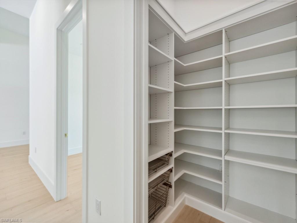 Undisclosed Address Naples, FL 34110 - Photo 8 of 27 a view of walk in closet with empty racks